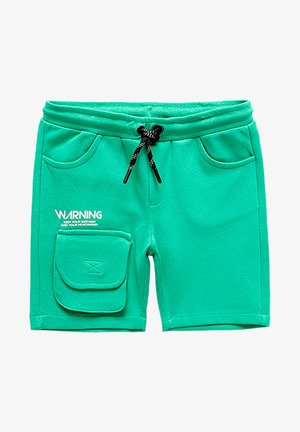 Turkis småbørnsshorts med elastisk talje, sort snøre, forlommer, klaplomme på venstre ben og hvid "WARNING" tekst på venstre side.