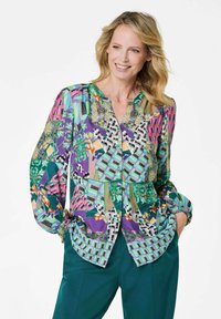 Blusa colorata con un mix di motivi geometrici e floreali, dotata di una chiusura con bottoni davanti, scollatura a V e polsini elasticizzati.