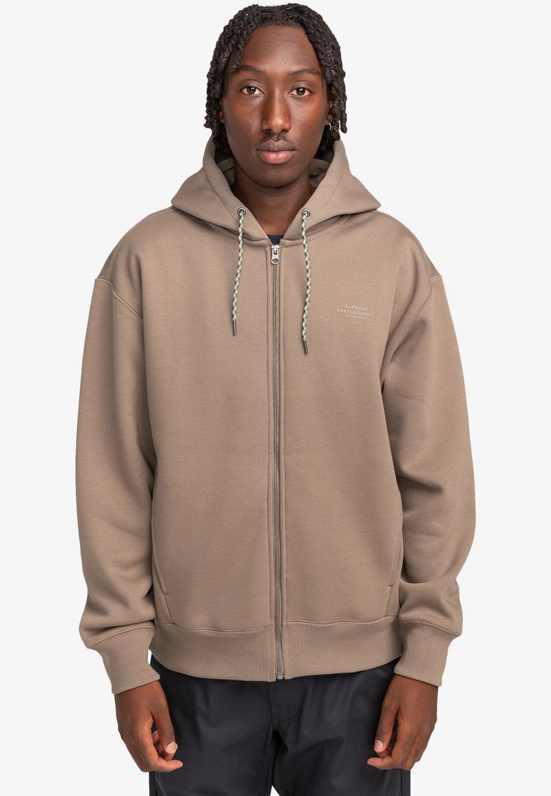 Brown zip-up hoodie with a drawstring hood, kangaroo pockets, and ribbed cuffs. Features subtle branding on the chest and a relaxed fit.