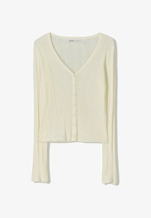 Cardigan a maniche lunghe color crema con scollatura a V, texture a coste e una fila di sei bottoni sul davanti. Design corto.