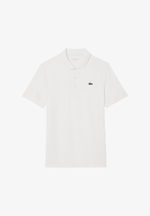 Hvid bomulds polo skjorte med korte ærmer, tre-knaps placket og et grønt Lacoste-logo på venstre bryst. Glat tekstur.