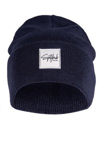 Navy knitted beanie with a turned-up cuff, featuring a square white label with black text. The texture is ribbed and stretchy.
