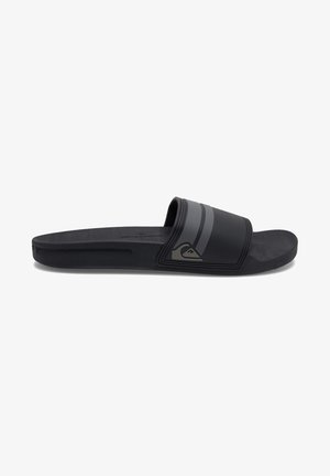 Black slide sandal with a rubber sole. Features a wide strap with black and gray stripes, and a textured surface. Logo on the strap.