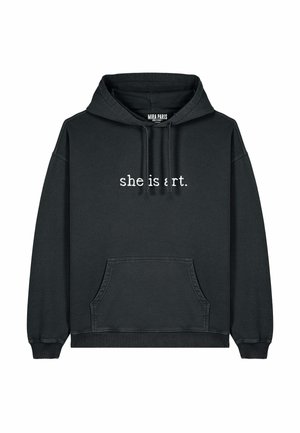 Black hoodie with front pocket, drawstring hood, and white text "she is art." on chest. Made from soft, textured fabric. Simple design.