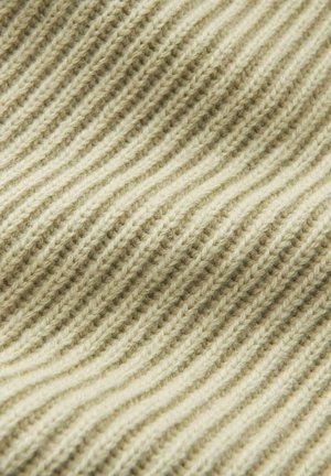 Knitted fabric in light beige with textured, wavy ribbed pattern. Soft, wool-like material with visible strands and subtle variation in color.