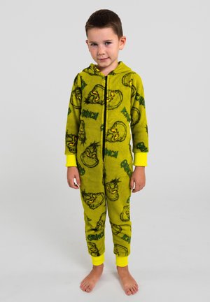 Tuta intera in pile verde con motivi del Grinch, chiusura con zip e dettagli gialli sui polsini e sul cappuccio. Tessuto morbido, copertura completa delle gambe.