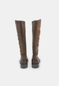 Brown leather knee-high boots with a slightly slouched design, rear zipper closure, and a low heel. Smooth texture with subtle variations.