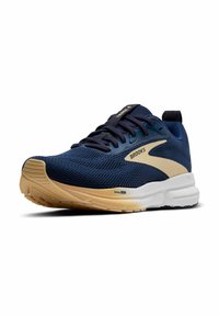 Marineblaue Sportschuhe mit Mesh-Obermaterial, crèmefarbenen Akzenten und einer strukturierten, weißen Sohle. Ausgestattet mit dicken Schnürsenkeln und einem gepolsterten Kragen für zusätzlichen Halt.