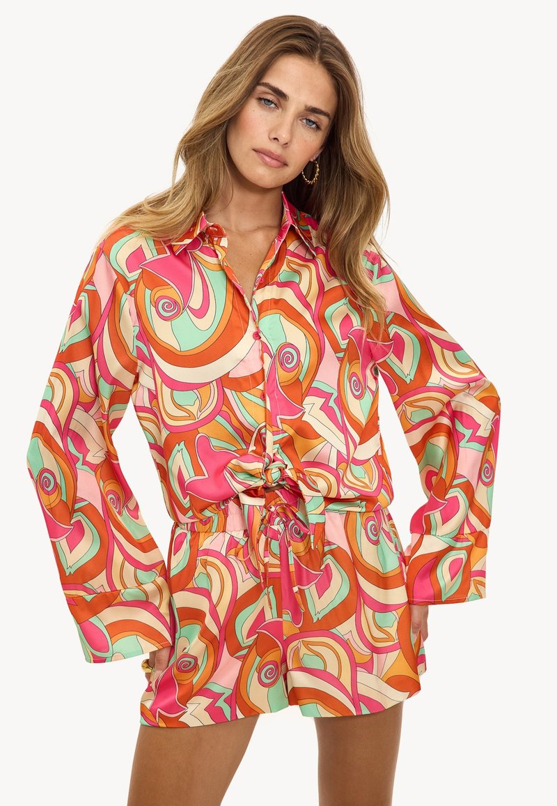 Conjunto de blusa y pantalones cortos de seda multicolor con remolinos en rosa, naranja y verde menta; corte holgado con cierre de botones y cintura atada.