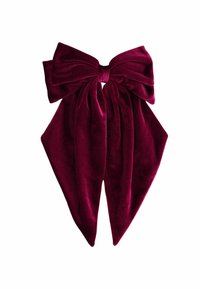 Burgundi sametist valmistatud juuksepael, millel on keskel suur, tekstureeritud nool ja kaks pikendatud saba, luues elegantse aksessuaari disaini.