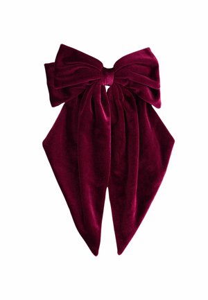 Burgundin samettiset hiuslenkit, joissa on suuri, teksturoitu solmu keskellä ja kaksi pitkää häntää, luoden elegantin asusteiden muotoilun.