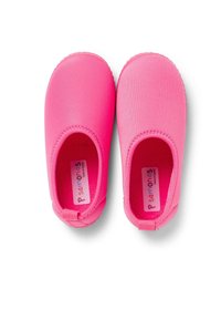 Pink slip-on shoes made of soft material, featuring a smooth texture and rounded shape. Inside has a logo label; no visible hardware.