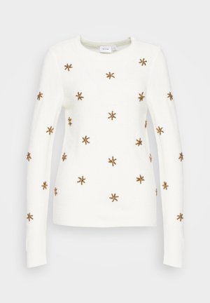 Valkoinen pitkähihainen neulepaita pyöreällä pääntiellä, koristeltu tasaisesti sijoitetuilla ruskeilla helmillä tehdyillä tähtimuotoisilla koristeilla.