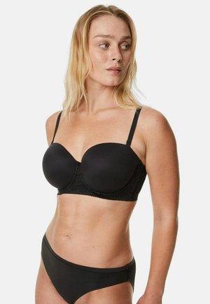 Zwarte gevoerde beha met gladde cups en kanten details aan de onderkant, met verstelbare banden. Gecombineerd met bijpassende zwarte onderbroek.