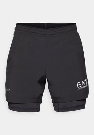 Black athletic shorts with a fitted inner layer, elastic waistband, and logo detailing on the lower left leg. Made from lightweight fabric.