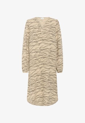 Beige jurk met een V-hals, lange mouwen en elastische manchetten, met een zwart golvend lijnpatroon over de gehele jurk. Middellange ontwerp.
