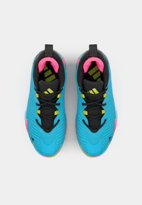 Blue athletic shoes with a textured upper, black laces, pink accents inside, and colorful sole details. Features a streamlined design.