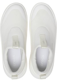 Białe buty slip-on z gładką tekstylną cholewą, teksturowanymi akcentami, wyściółką kołnierza i białą gumową podeszwą. Wewnątrz znajdują się oznaczenia marki "crocs".