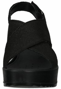 Black platform sandals featuring a textured upper with crisscross straps and an open toe design. The sole is solid and slightly raised.