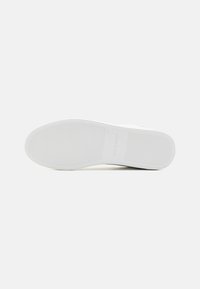White rubber shoe sole with textured grip pattern and branding. Labeled size 41, designed for durability and traction. Clean, minimalist design.