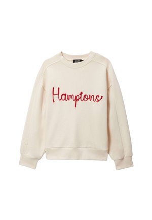 Sweat-shirt couleur crème avec manches longues et texte "Hamptons" en cursive rouge brodé sur le devant.