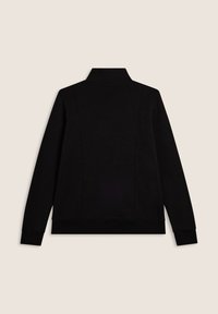 Giacca nera a maniche lunghe con colletto alto, dettagli delle cuciture sul retro, polsini e orlo a costine, esposta su uno sfondo beige.