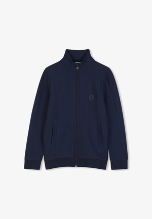 Veste zippée bleu marine avec col montant, texture côtelée, deux poches latérales et un écusson logo rond sur la poitrine.