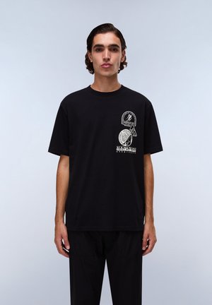 Black cotton t-shirt featuring three circular white graphic prints on the front. Short sleeves and a relaxed fit with a crew neck design.