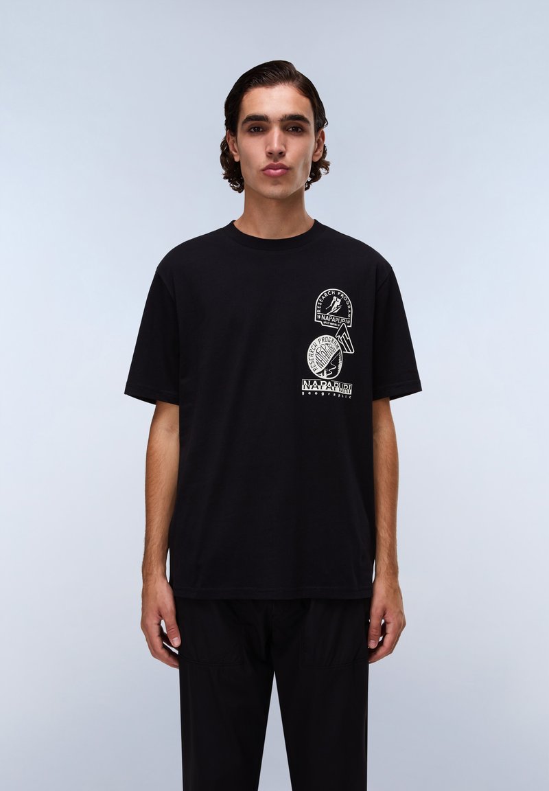 Černé bavlněné tričko s třemi kulatými bílými grafickými potisky na přední straně. Krátké rukávy a volný střih s kruhovým výstřihem.