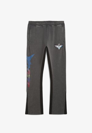 Black and grey sweatpants with side pockets, featuring a blue and red graphic design on one leg and a logo patch on the other.