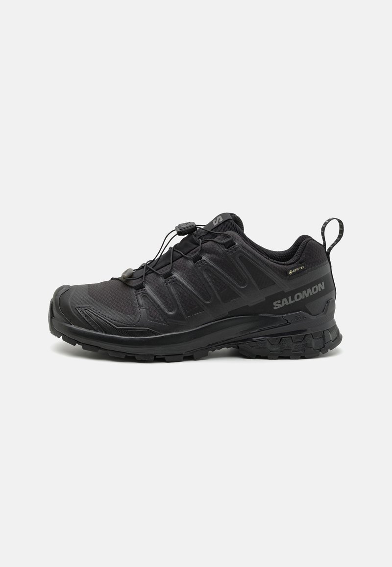 Black athletic shoe with a textured synthetic upper, cushioned sole, and a quick-lacing system. Features a reinforced toe and heel.
