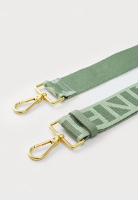 Green adjustable strap made of fabric with a textured finish, featuring gold-tone metal clasps and a logo detail printed along the length.