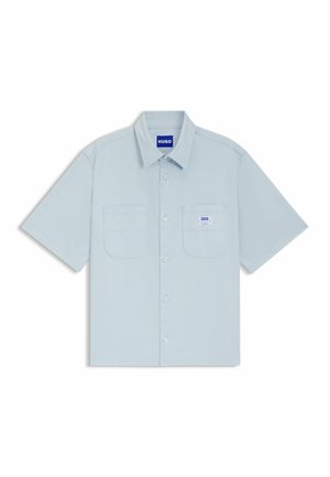Hellblaues kurzärmeliges Hemd mit Knöpfen und zwei Fronttaschen, von denen eine ein kleines weißes Etikett mit der Aufschrift "HUGO" trägt.