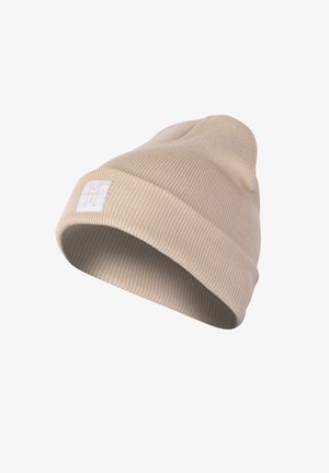 Knit beanie in light beige with a ribbed texture. Features a folded cuff and a small white logo patch on the side.