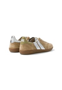 Paire de baskets en daim beige avec des bandes argentées, semelles marron et accents verts et argentés au talon, vues de dos sur fond blanc.