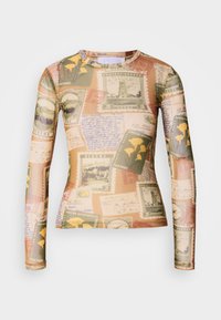 Long-sleeve shirt features a blend of vintage postage stamps and handwritten notes in earthy tones of beige, green, and yellow.