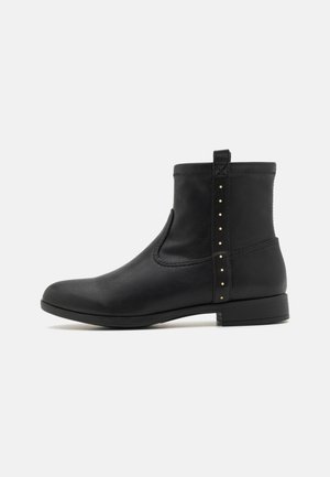 Black leather ankle boot with a rounded toe, decorative studs on the side, elastic panel, and a low block heel. Smooth texture with a simple design.