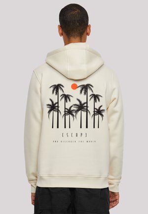 Cream hoodie featuring a black palm tree graphic and a red sun on the back, with text reading "ESCAP3 AND DISCOVER THE WORLD."