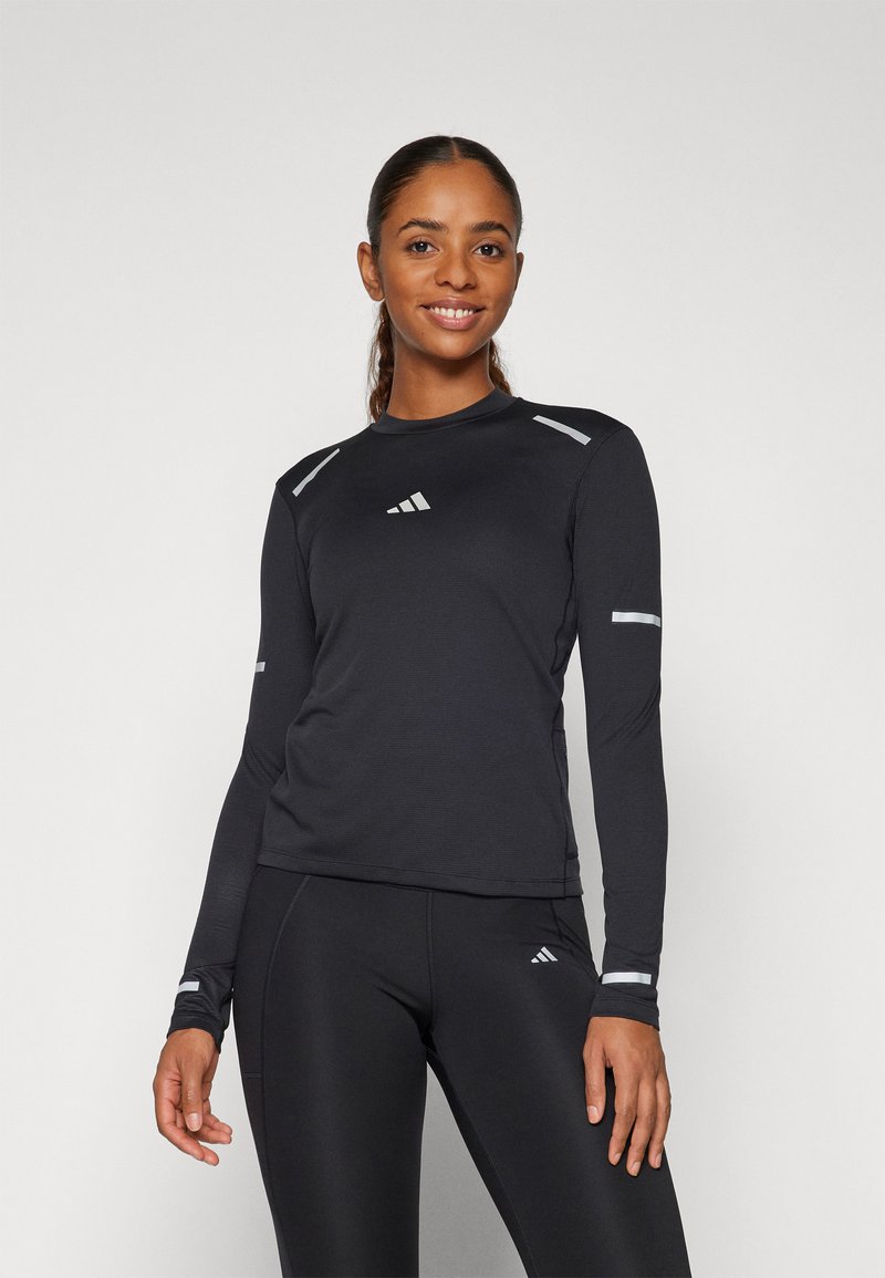 Langärmliges schwarzes Sportshirt mit reflektierenden Akzenten an Schultern und Ärmeln, das einen runden Halsausschnitt und ein schlankes, eng anliegendes Design aufweist.