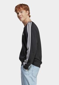 adidas Sportswear ESSENTIALS 3-STRIPES - Športni pulover - black