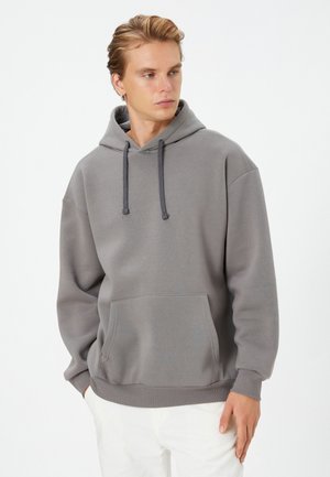 Gray pullover hoodie made of soft fabric, featuring a front kangaroo pocket, adjustable drawstring hood, and ribbed cuffs and hem.