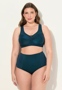 Bikini a vita alta in verde scuro, con un motivo testurizzato. Top con spalline larghe e un fiocco decorativo al centro.
