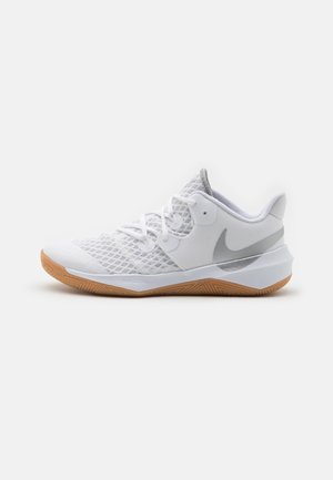 White athletic sneaker with mesh upper, gray Nike swoosh, white laces, and gum rubber sole shown from the side against a white background.