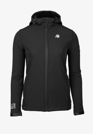 Black softshell jacket with a zip front, adjustable hood, and contrast stitching. Features logo on chest and text detail on sleeve.
