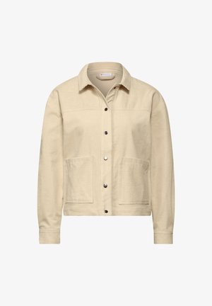 Beżowa kurtka z kordurowego materiału z guzikiem z przodu, dwoma przednimi kieszeniami i kołnierzem. Teksturowany materiał i dopasowane mankiety dodają detali.