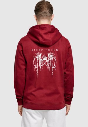 Maroon hoodie made of soft fabric, featuring a white graphic print of "SLEEP TOKEN" and intricate designs on the back. Textured finish, drawstring hood.