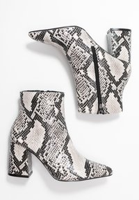 Snakeskin ankle boots in shades of gray and white, featuring a pointed toe, a zip closure, and a chunky heel with a glossy finish.