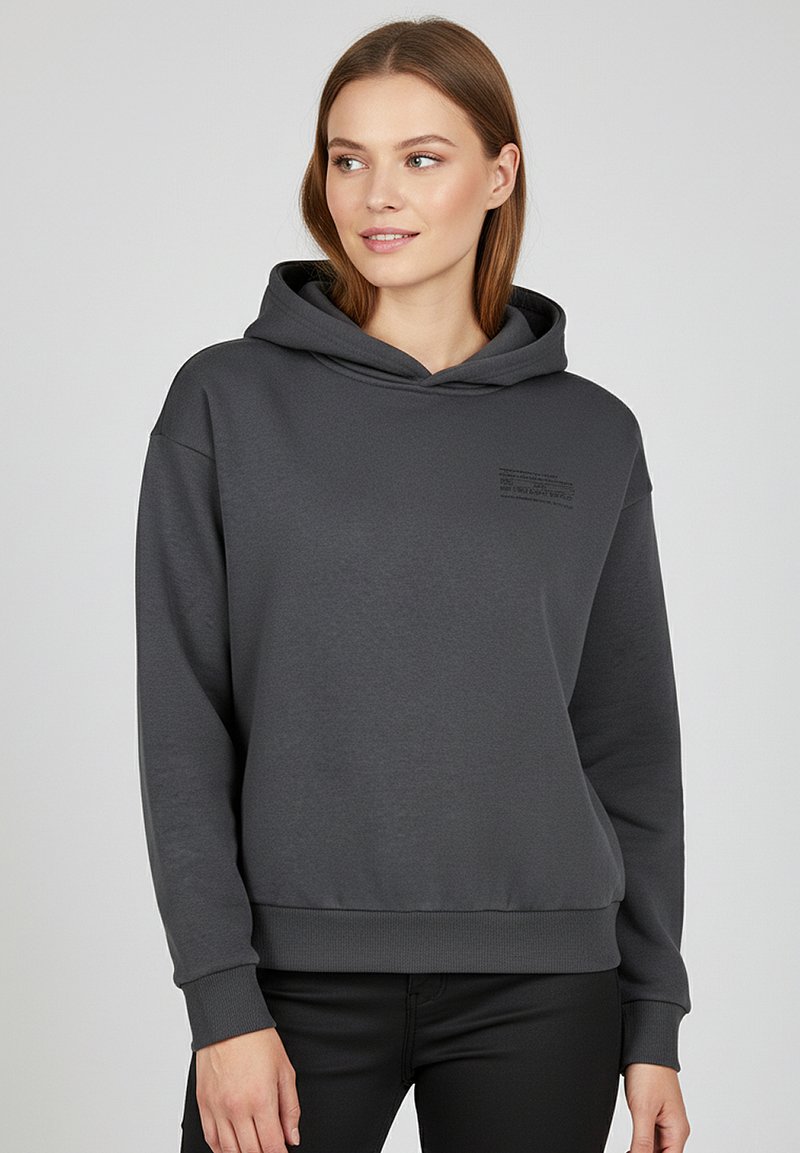Gray hoodie made of soft fabric with a front kangaroo pocket, ribbed cuffs, and a small embossed text detail on the chest.