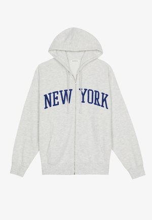 Hellgrauer Zip-Hoodie mit Kapuze, Fronttaschen und "NEW YORK" in großen dunkelblauen Buchstaben auf der Brust.