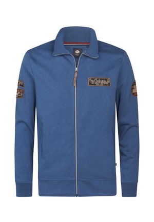 Blauwe rits-trui gemaakt van zachte stof, met een geribde kraag en manchetten, twee zijzakken en decoratieve patches op de mouwen.